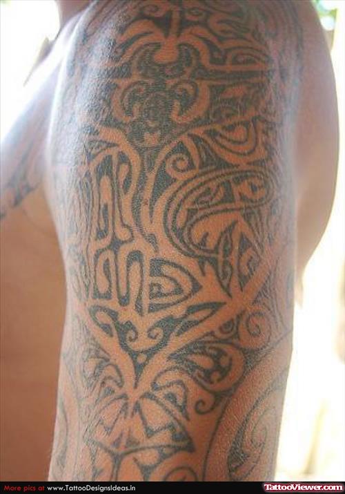 Awful Hawaiian Tattoo On Left Half Sleeve