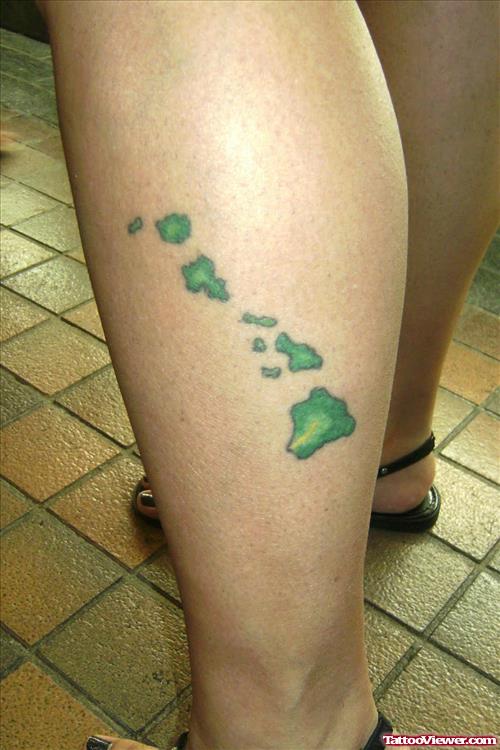 Green Ink Hawaiian Tattoo On Left Leg