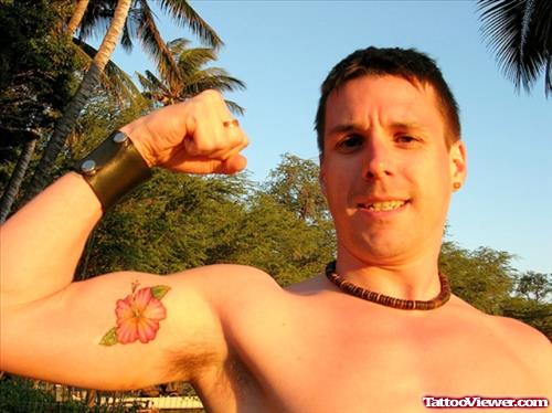 Man Showing His Hawaiian Flower Tattoo