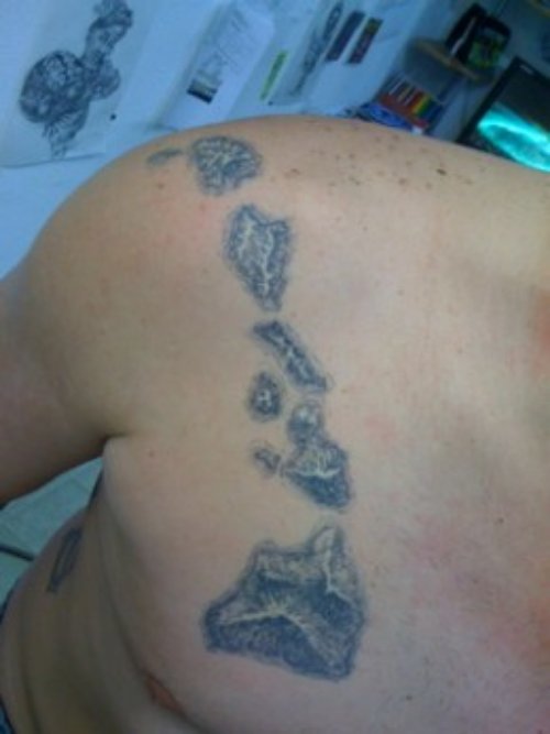 Grey Ink Hawaiian Tattoo On Right Collarbone