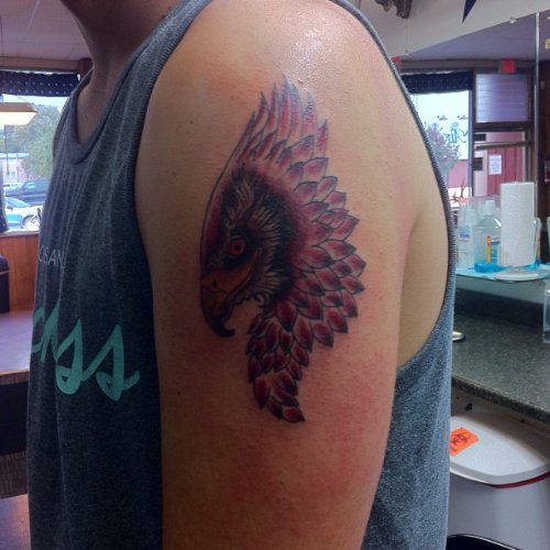 Red Ink Hawk Head Tattoo On Left Bicep