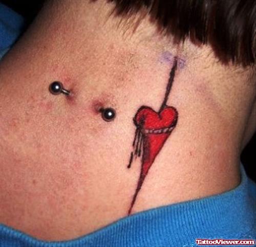 Nape Piercing and Red Heart Tattoo On Back Neck