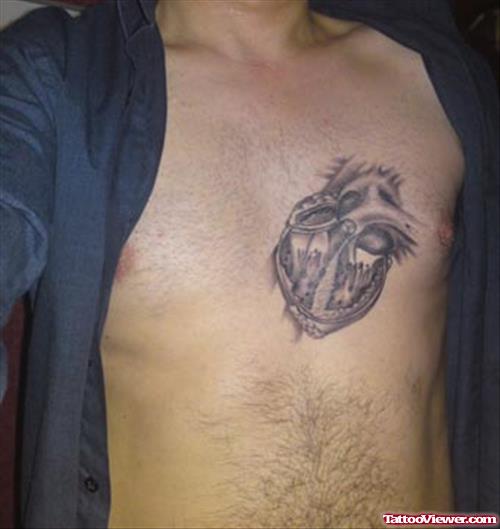 Grey Ink Human Heart Tattoo On Man Chest