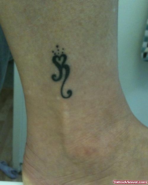 Black Ink Tribal Heart Tattoo On Ankle