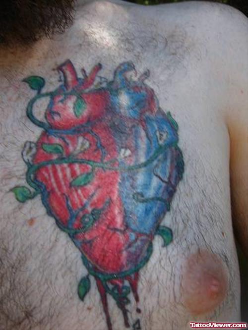 Awesome Colored Heart Tattoo On Man Chest