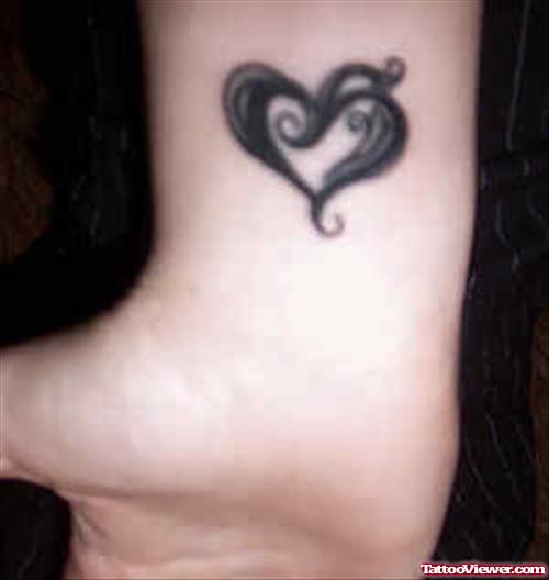 Awesome Black Ink Heart Tattoo On Wrist