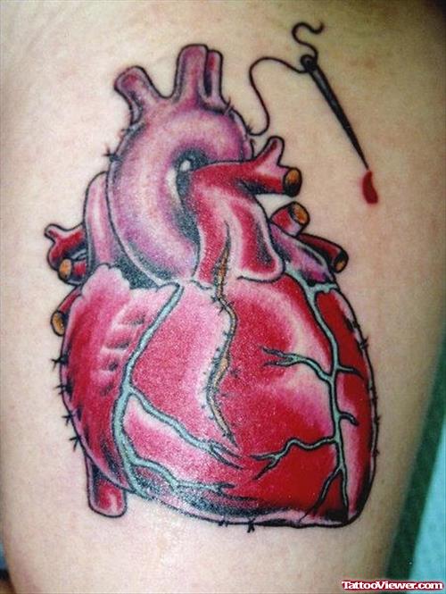 Red Ink Heart Tattoo On Bicep