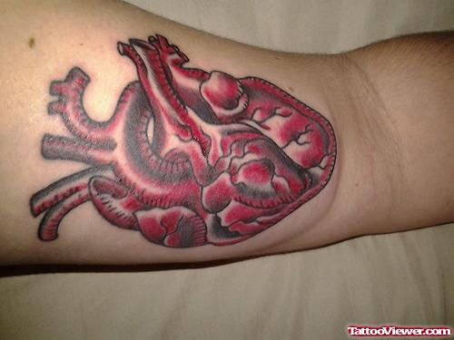 Red Human Heart Tattoo On Leg