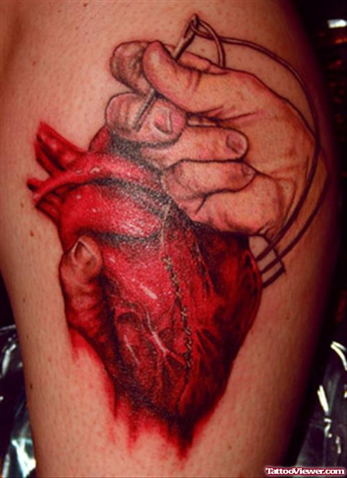 Sewing Heart With Needle And Thread Tattoo