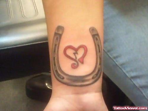 Grey Ink Horseshoe And Heart Tattoo