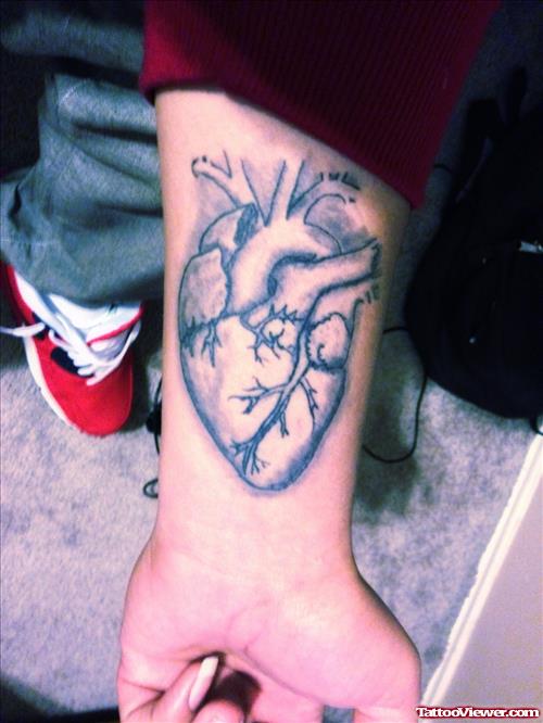 Grey Ink Human Heart Tattoo On Left Wrist