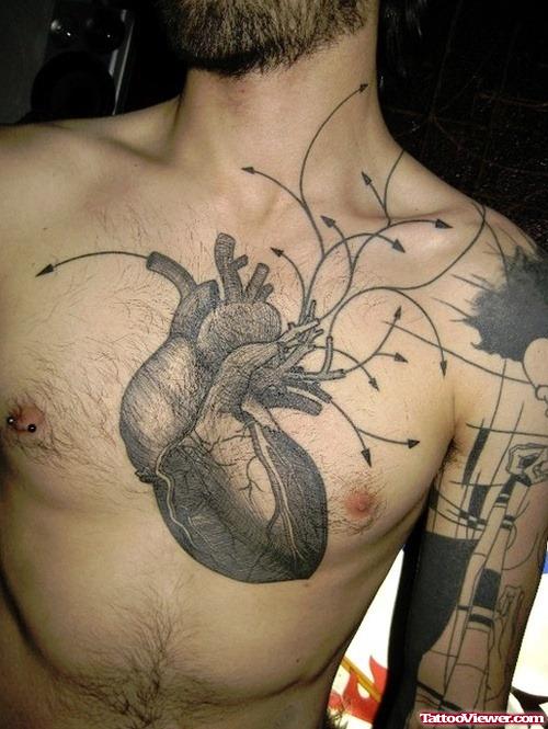 Grey Ink Heart Tattoo On Man Chest