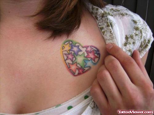 Colored Stars And Heart Tattoo On Girl Chest