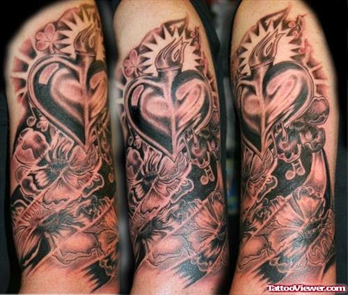 Grey Ink Heart Tattoo On Left Sleeve