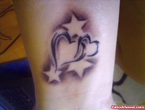 Grey Ink Stars And Heart Tattoo On Wrist