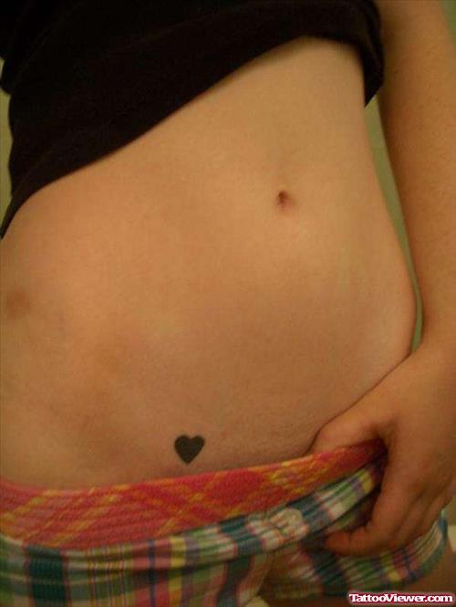 Tiny Black Heart Tattoo On Hip