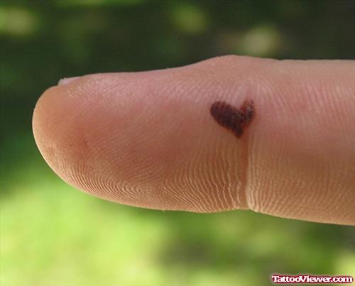 Tiny Black Heart Tattoo On Finger