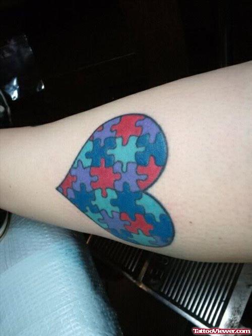 Colored Puzzle Heart Tattoo On Leg
