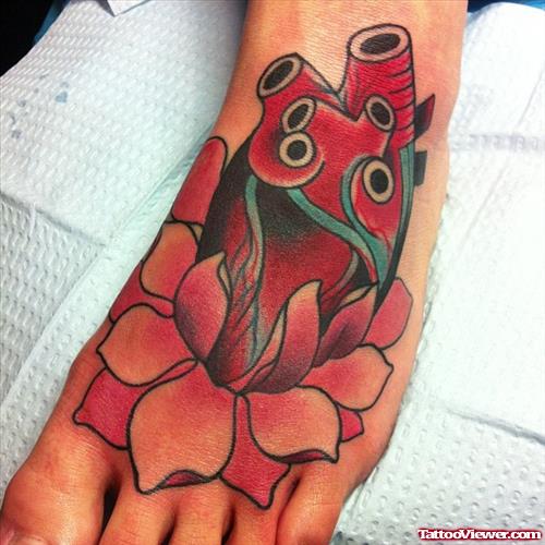 Color Flower And Human Heart Tattoo On Left Foot
