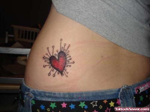 Red Pin Heart Tattoo On Lowerback