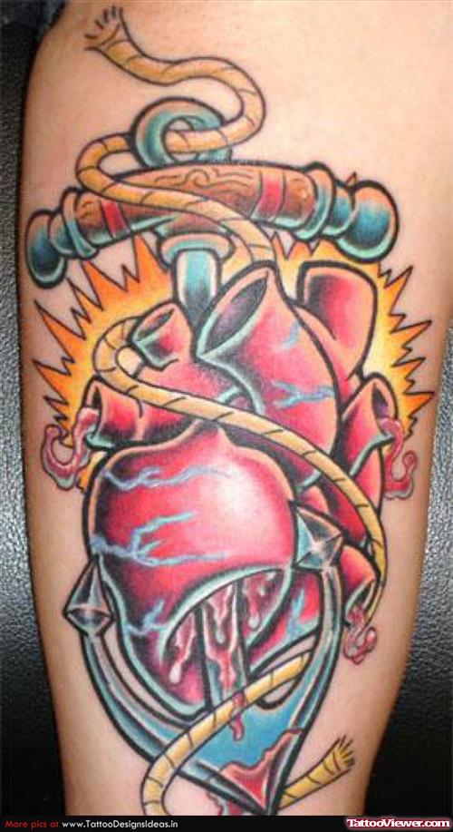 Blue Ink Anchor And Real Heart Tattoo