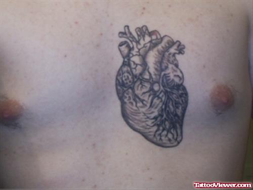 Best Grey Ink Heart Tattoo On Man Chest