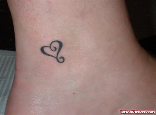 Tiny Black Heart Tattoo On Leg