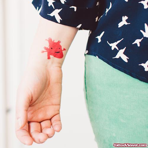 Red Human Heart Tattoo On Wrist