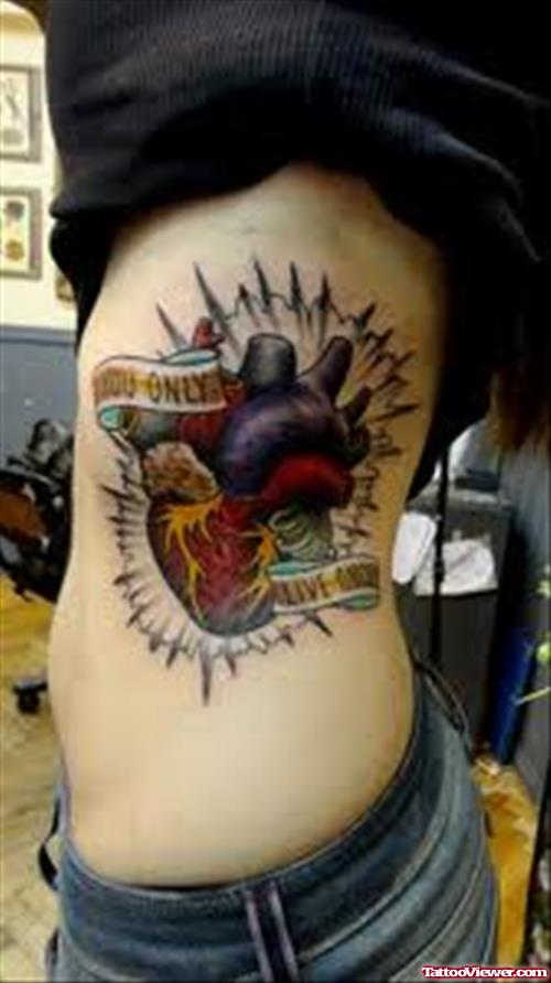 Colored Human Heart Tattoo On Rib Side