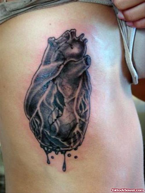 Awesome Grey Ink Human Heart Tattoo On Side Rib