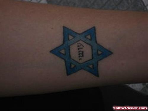 Blue ink Star and Hebrew Tattoo