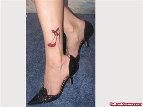 Red Ink Heel Tattoo On Girl Leg
