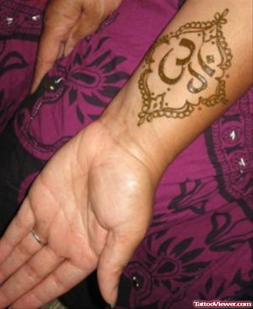 Religious Om Symbol Henna Tattoo On Left Forearm