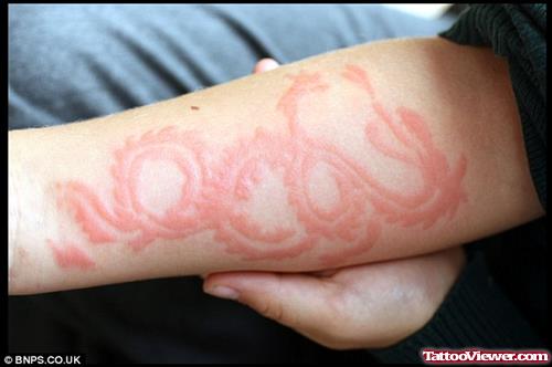 Red Ink Dragon Henna Tattoo On Arm