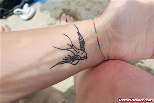 Grey Ink Flying Bird Henna Tattoo On Wrist