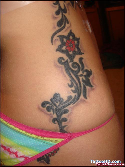 Black Tribal Flowr Henna Tattoo On Side Rib