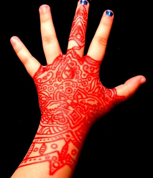 Red Ink Henna Tattoo On Left Hand