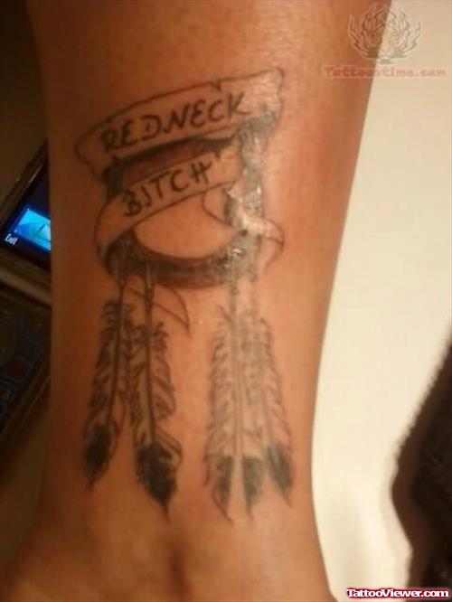 Grey Ink Horse Shoe And Feathers With Red Neck Bitch Banner Tattoo