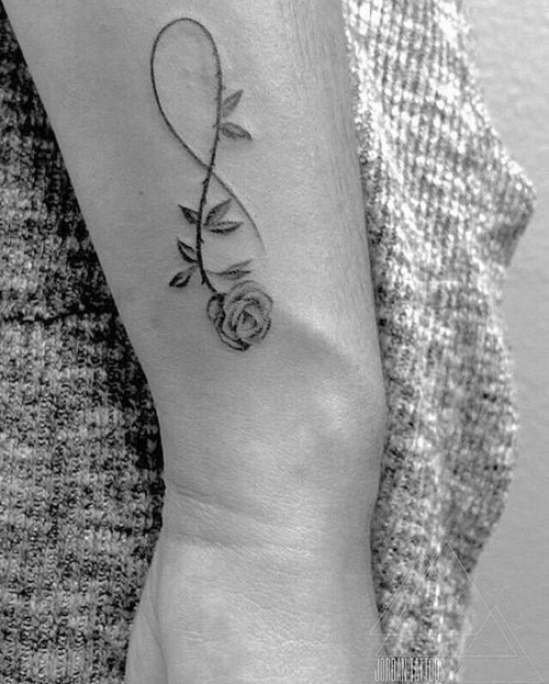 Rose Flower Bud Infinity Tattoo On Outer Forearm