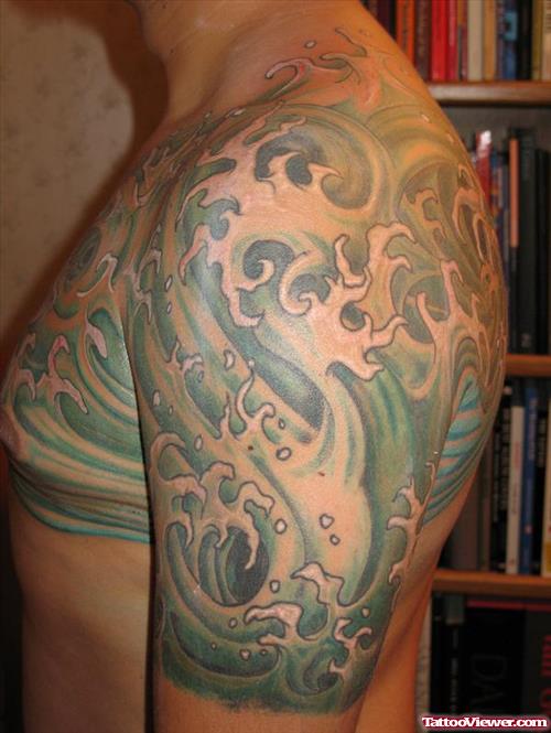 Green Ink Japanese Waves Tattoo On Left Shoulder