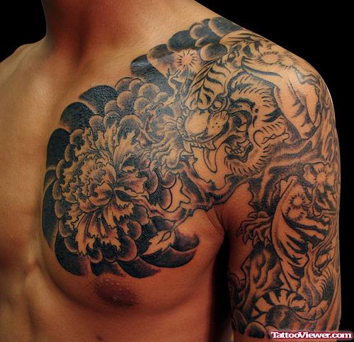 Grey Ink Japanese Tattoo On Man Chest And Half Sleeve