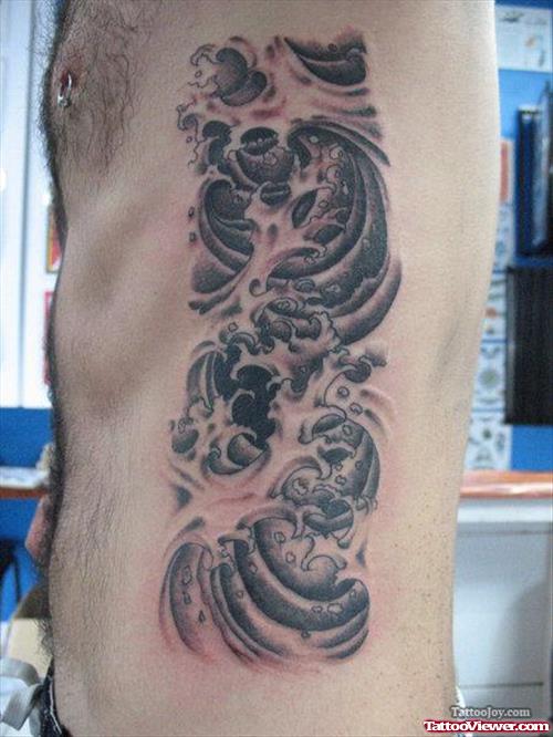 Grey Ink Japanese Tattoo On Man Side Rib