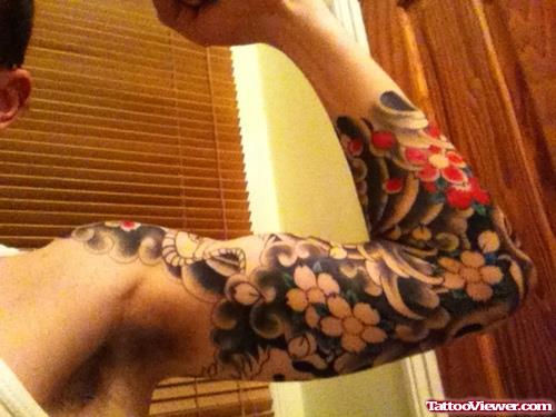 Grey Ink Japanese Flowers Tattoo On Arm
