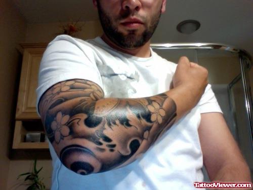 Grey Ink Japanese Tattoo On Man Right Sleeve