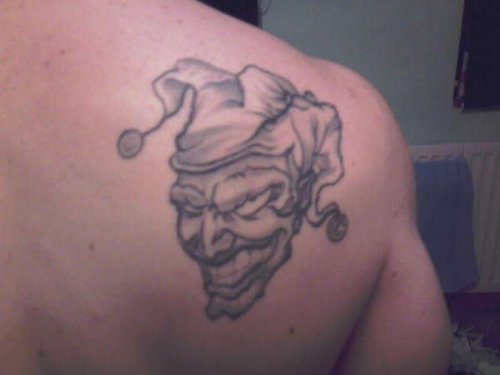 Grey Ink Jester Skull Tattoo On Right Back Shoulder