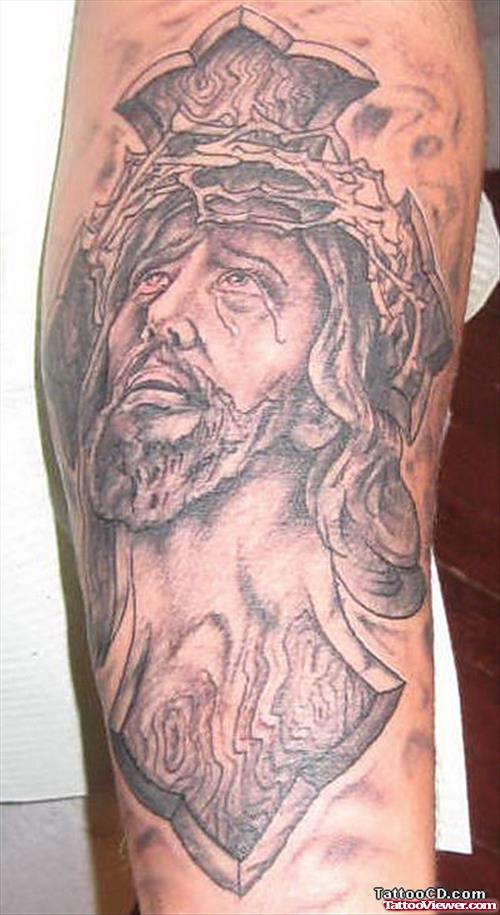 Grey Ink Cross And Jesus Head Tattoo On Left Sleeve