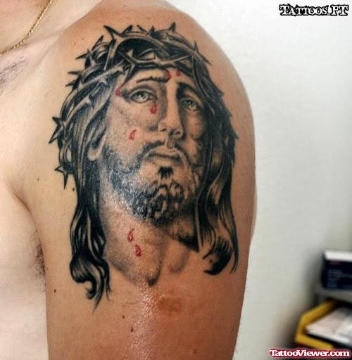 Grey Ink Jesus Head Tattoo On Man Left Shoulder