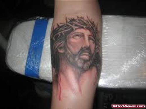 Grey Ink Jesus Head Tattoo On Arm