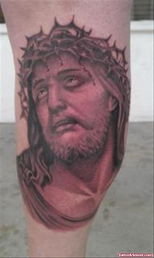 Grey Ink Jesus Face Tattoo On Right Leg