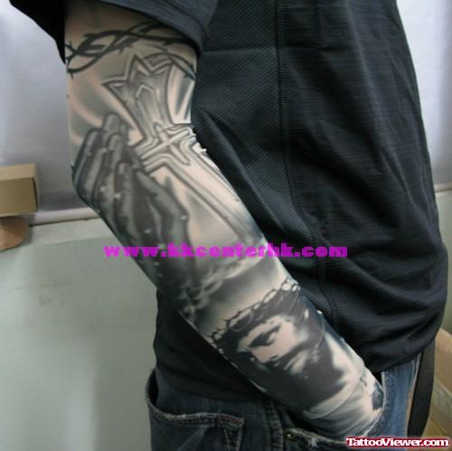 Grey Ink Cross And Jesus Tattoo On Right Sleeve